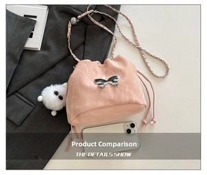 Pink bucket bag with metallic butterfly detail, drawstring closure, and plush charm