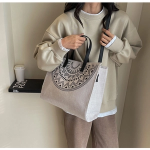 Ethnic style large canvas tote bag with geometric print shown on model's shoulder