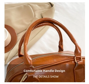 Vue détaillée du sac à main en cuir caramel avec poignée épaisse et zip doré