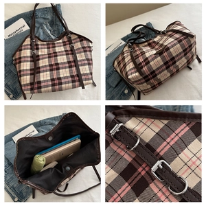 Detail of checkered tote bag with silver buckle and spacious interior compartment
