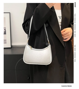 Silver crescent underarm bag with pleated faux leather texture and gold zipper detail