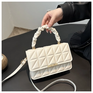 Quilted cream crossbody bag with a ruched handle and golden hardware for women