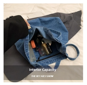Detail of denim tote bag interior showing spacious capacity and inner zipper pocket