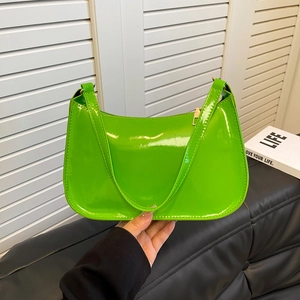 Fashionable lime green patent leather shoulder bag with sleek curved design and gold zipper