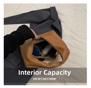 Internal view of brown woven bag showing capacity with cosmetics and golden zipper