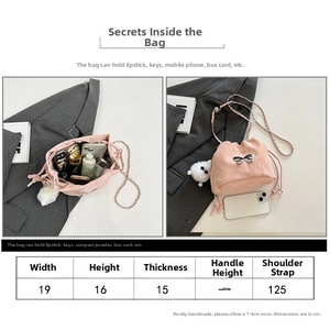 Pink drawstring bucket bag detail with silver bow charm and size chart specifications