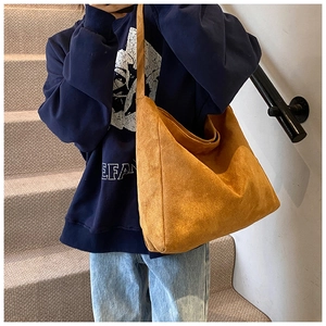Close-up of mustard yellow suede tote bag showing soft texture and large capacity