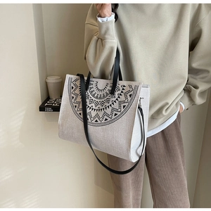 Close-up of bohemian geometric pattern canvas tote bag with black leather handle