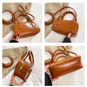 Vues détaillées d'un sac bowling rétro marron montrant le cuir et les fermetures éclair