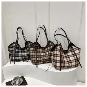 Detailed comparison of three plaid canvas tote bags with leather handles and metallic logos