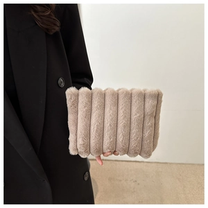 Detail of light khaki plush clutch bag with vertical striped texture and soft faux fur