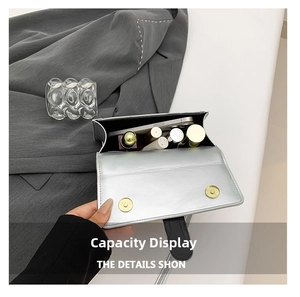 Interior view of silver metallic bag showing capacity for phone and cosmetics