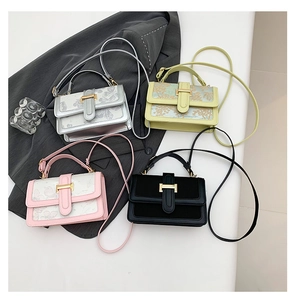 Flat lay of four stylish crossbody bags in silver, yellow, pink, and black with floral prints