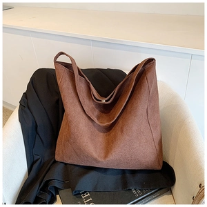Detailed close-up of brown suede oversized tote bag with minimalist wide shoulder strap
