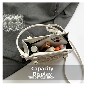 Top view of the white handbag interior showing its large capacity for phone and cosmetics