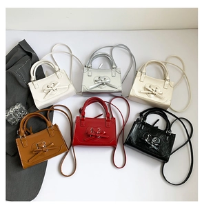 Flat lay of multiple small crossbody bags in six colors with heart decorative detail