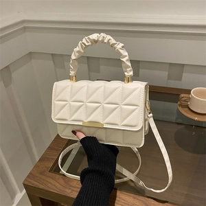 Minimalist cream white quilted handbag with pleated handle and golden hardware details