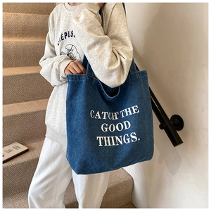 Large denim tote bag for women featuring a white Catch The Good Things printed slogan
