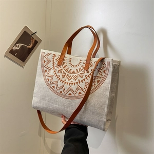 Minimalist beige tote bag with brown geometric patterns and leather handles for daily use