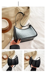 Detail view of black hobo bag with PU leather texture and gold hardware accents