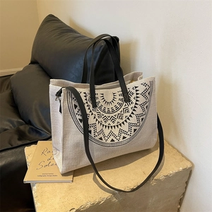 Minimalist canvas tote bag with black geometric tribal print and long shoulder straps