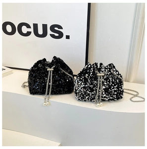 Macro shot of sequin bucket bags featuring metallic luster, chain cords and pearl charms