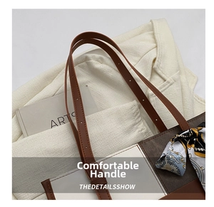 Detail view of tote bag featuring brown leather straps and decorative floral silk scarf