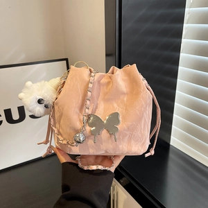 Chic pink pleated drawstring bucket bag with silver butterfly metal detail and chain strap