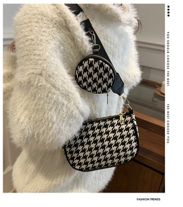 Detail of houndstooth crossbody bag with mini round pouch on the wide strap