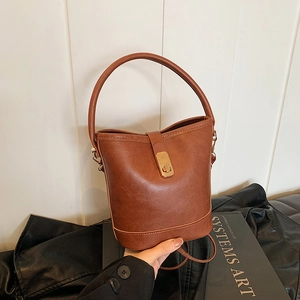 Vintage brown textured leather bucket bag with gold metal lock and round top handle