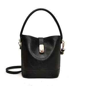 Retro black bucket bag with textured leather, gold metal lock, and detachable strap