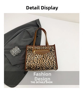Flat lay of leopard print tote bag with brown handles and external zipper pocket