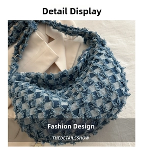 Close-up of blue and white checkered denim hobo bag with frayed edges and street style retro texture