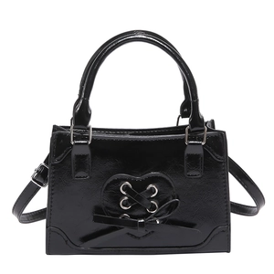 Glossy black heart ribbon shoulder bag with bow detail and adjustable strap