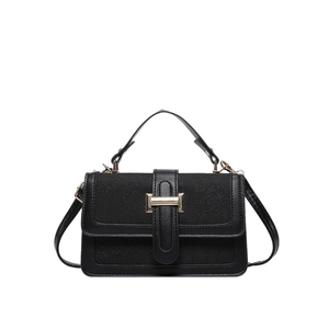 Minimalist black leather crossbody bag with light gold buckle on white background