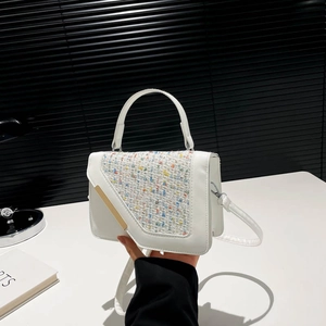 Modern white leather square bag with a vibrant tweed flap and gold metal trim detail