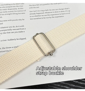 Detail of adjustable off-white woven strap with a silver metal slider buckle