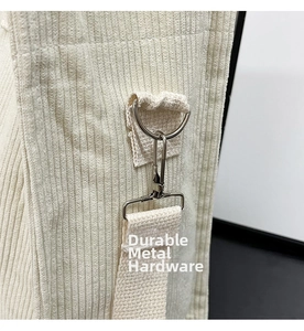 Macro detail of high-quality metal hardware and corduroy fabric on a large tote bag