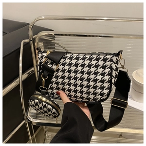 Detail of houndstooth shoulder bag with wide strap and matching round coin purse