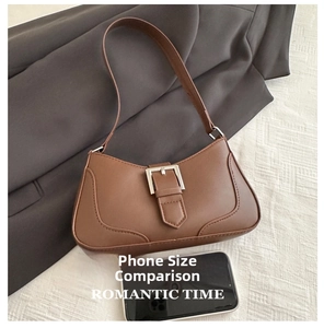 Retro brown leather shoulder bag detail with silver buckle and mobile phone size comparison