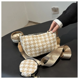 Detail of houndstooth crossbody bag with mini round coin purse and wide strap