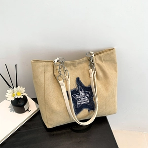 Khaki canvas tote bag with star patch and metal chain strap for daily commute
