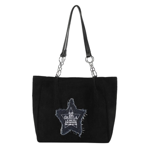Black corduroy tote bag with blue denim star patch and metal chain shoulder straps