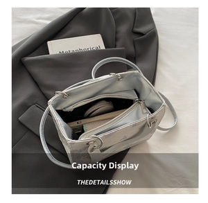 Internal view of the contrast color tote bag showing multi-compartment storage and zipper pocket