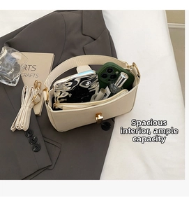 Top view of beige leather handbag interior showing large capacity and adjustable strap