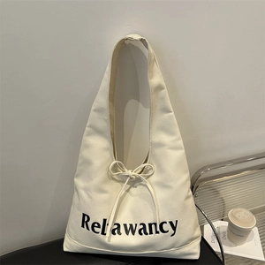 Minimalist off-white canvas tote bag with Relawancy print and bow drawstring closure