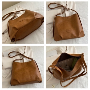 Detail view of large brown PU leather tote bag with lychee texture and spacious interior