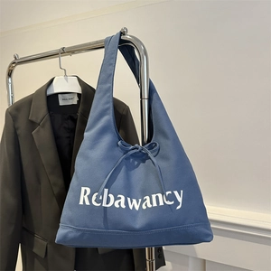 Large dark blue canvas hobo tote bag with white lettering and bow drawstring detail