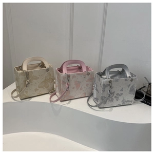 Three elegant flap bags with butterfly patterns in gold, pink, and silver finishes