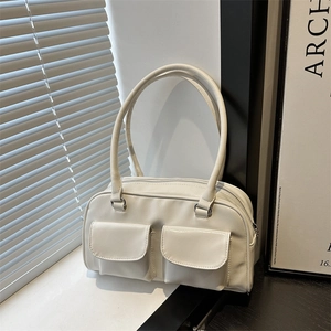 Minimalist white faux leather shoulder bag with dual front pockets and long top handles